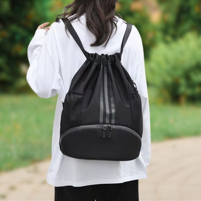 femme porte sac à dos sport noir dans un parc