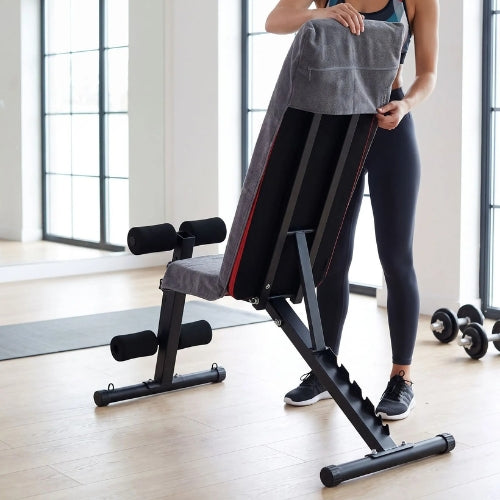 femme règle capuche de la serviette de sport sur le haut d un banc de fitness
